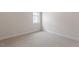 Neutral bedroom with carpeting, baseboard trim, and a single window at 12 Beacon Ridge Blvd, Chapel Hill, NC 27516