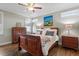 Comfortable bedroom featuring a ceiling fan, wooden furniture, and an inviting queen-sized bed at 12 Beacon Ridge Blvd, Chapel Hill, NC 27516