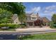 A beautiful, large clubhouse with stone chimney, covered front porch and well manicured landscaping at 12 Beacon Ridge Blvd, Chapel Hill, NC 27516