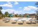 Community pool featuring lounge chairs, tables with umbrellas, a slide, and a gazebo offers a relaxing outdoor experience at 12 Beacon Ridge Blvd, Chapel Hill, NC 27516