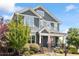 Charming two-story home with a covered front porch, stone accents, and a well-manicured lawn at 12 Beacon Ridge Blvd, Chapel Hill, NC 27516