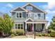 Charming two-story home with a covered front porch, stone accents, and a well-manicured lawn at 12 Beacon Ridge Blvd, Chapel Hill, NC 27516