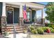 Inviting covered front porch with stone accents, seating area, and an American flag at 12 Beacon Ridge Blvd, Chapel Hill, NC 27516