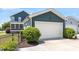 Well maintained two car garage with clean driveway and manicured shrubbery at 12 Beacon Ridge Blvd, Chapel Hill, NC 27516