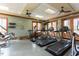 Gym featuring treadmills, elliptical, weights, and doors to the outside for an open and convenient workout experience at 12 Beacon Ridge Blvd, Chapel Hill, NC 27516