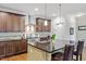 Modern kitchen with granite countertops, stainless steel appliances, and dark wood cabinets at 12 Beacon Ridge Blvd, Chapel Hill, NC 27516