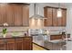 Kitchen with stainless steel oven and vent hood, granite countertops, and tile backsplash at 12 Beacon Ridge Blvd, Chapel Hill, NC 27516