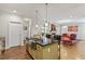 Kitchen island with sink and view to living area with a red sofa and area rug at 12 Beacon Ridge Blvd, Chapel Hill, NC 27516