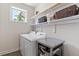 Functional laundry room with modern washer, dryer, and shelving at 12 Beacon Ridge Blvd, Chapel Hill, NC 27516