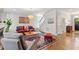 Spacious living room features a comfortable gray chair, red sofa, area rug, and staircase at 12 Beacon Ridge Blvd, Chapel Hill, NC 27516