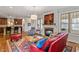 Open concept living space with kitchen, fireplace, hardwood floors, and area rug at 12 Beacon Ridge Blvd, Chapel Hill, NC 27516