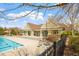 Community pool features clubhouse with shaded veranda and poolside seating at 12 Beacon Ridge Blvd, Chapel Hill, NC 27516