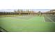 Tennis courts with tall fences offer a private and picturesque setting for an active outdoor lifestyle at 12 Beacon Ridge Blvd, Chapel Hill, NC 27516