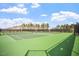 Tennis courts with tall fences offer a private and picturesque setting for an active outdoor lifestyle at 12 Beacon Ridge Blvd, Chapel Hill, NC 27516