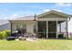 Backyard patio featuring outdoor seating, fire pit, grill and a screened in porch area at 12404 Huntley Chase Dr, Durham, NC 27703