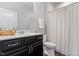 The full bathroom offers dark cabinetry, updated fixtures, and a shower/tub combo at 12404 Huntley Chase Dr, Durham, NC 27703