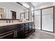 An updated bathroom with a glass-enclosed shower, double sink vanity, and dark cabinetry at 12404 Huntley Chase Dr, Durham, NC 27703