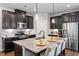 Stylish kitchen featuring dark cabinetry, granite countertops, and stainless steel appliances at 12404 Huntley Chase Dr, Durham, NC 27703