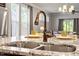 Close-up of the kitchen sink featuring granite countertops, faucet, and window at 12404 Huntley Chase Dr, Durham, NC 27703