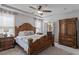 The large primary bedroom boasts hardwood furnishings, a decorative fan light, and neutral carpeting at 12404 Huntley Chase Dr, Durham, NC 27703