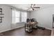 Bright office space with dark wood floor, a desk, shelving, and natural light from two windows at 12404 Huntley Chase Dr, Durham, NC 27703