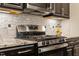 Modern gas range and oven with stylish subway tile backsplash and granite countertops at 12404 Huntley Chase Dr, Durham, NC 27703