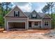 Charming home with gray siding, black shutters, an attached garage, and professional design at 125 Purslane Dr, Franklinton, NC 27525