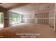 Spacious living room with drywall, large windows providing natural light and outdoor views at 125 Purslane Dr, Franklinton, NC 27525