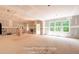 Large living room with fireplace and large windows with scenic outside views at 125 Purslane Dr, Franklinton, NC 27525