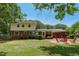 Two story home featuring a brick patio, fire pit, and well-maintained lawn, perfect for entertaining at 1274 Candlewood Dr, Elon, NC 27244