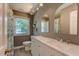 Bright bathroom featuring a double sink vanity, neutral paint, and plenty of natural light at 1274 Candlewood Dr, Elon, NC 27244