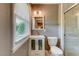Stylish bathroom featuring a modern vanity, a toilet, and a window for natural light at 1274 Candlewood Dr, Elon, NC 27244