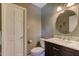Cozy bathroom features a marble countertop, a round mirror, and a white toilet at 1274 Candlewood Dr, Elon, NC 27244