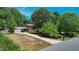 Traditional brick home with a long driveway and lush green surroundings under a sunny sky at 1274 Candlewood Dr, Elon, NC 27244