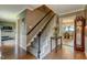 Inviting foyer with hardwood floors, staircase, and a glimpse into the elegant dining area at 1274 Candlewood Dr, Elon, NC 27244