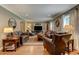 Spacious living room with hardwood floors, plush leather furniture, and ample natural light at 1274 Candlewood Dr, Elon, NC 27244