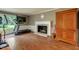Bright living room showcasing fireplace, wood flooring and exercise equipment at 1274 Candlewood Dr, Elon, NC 27244