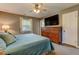 Comfortable main bedroom featuring a wooden dresser, bright window, and plush carpeting at 1274 Candlewood Dr, Elon, NC 27244