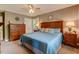 Inviting main bedroom with a plush bed, soft lighting, and ample storage space with wood dresser at 1274 Candlewood Dr, Elon, NC 27244