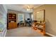 Well-lit office space with built-in shelving, a computer setup, and ample workspace for productivity at 1274 Candlewood Dr, Elon, NC 27244