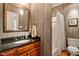 Full bathroom with wood cabinets, granite countertops, shower with curtain and neutral décor at 1312 Glenden Falls Way, Raleigh, NC 27614