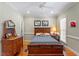 Cozy bedroom with wood furnishings, complemented by natural light and soft, neutral wall colors at 1312 Glenden Falls Way, Raleigh, NC 27614