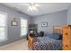 Comfortable bedroom with a wooden bed frame, window view and desk space at 1312 Glenden Falls Way, Raleigh, NC 27614