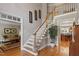 Grand foyer with hardwood floors, decorative staircase, and views into the living spaces at 1312 Glenden Falls Way, Raleigh, NC 27614