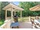 Charming backyard gazebo features a grill, table and chairs; perfect for outdoor dining and relaxation at 1312 Glenden Falls Way, Raleigh, NC 27614