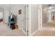 Upstairs hallway with carpet floors, bright white walls, and doorway to room featuring a TV at 1312 Glenden Falls Way, Raleigh, NC 27614
