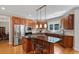 Modern kitchen featuring stainless steel appliances, a central island, and custom cabinetry at 1312 Glenden Falls Way, Raleigh, NC 27614