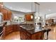 Gourmet kitchen boasts a large island with seating and top-of-the-line appliances and granite countertops at 1312 Glenden Falls Way, Raleigh, NC 27614