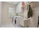 Functional laundry room with washer, dryer, sink, storage, and a bright, clean design at 1312 Glenden Falls Way, Raleigh, NC 27614