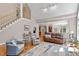 Open-concept living area with hardwood floors, staircase, neutral colors, and ample natural light at 1312 Glenden Falls Way, Raleigh, NC 27614